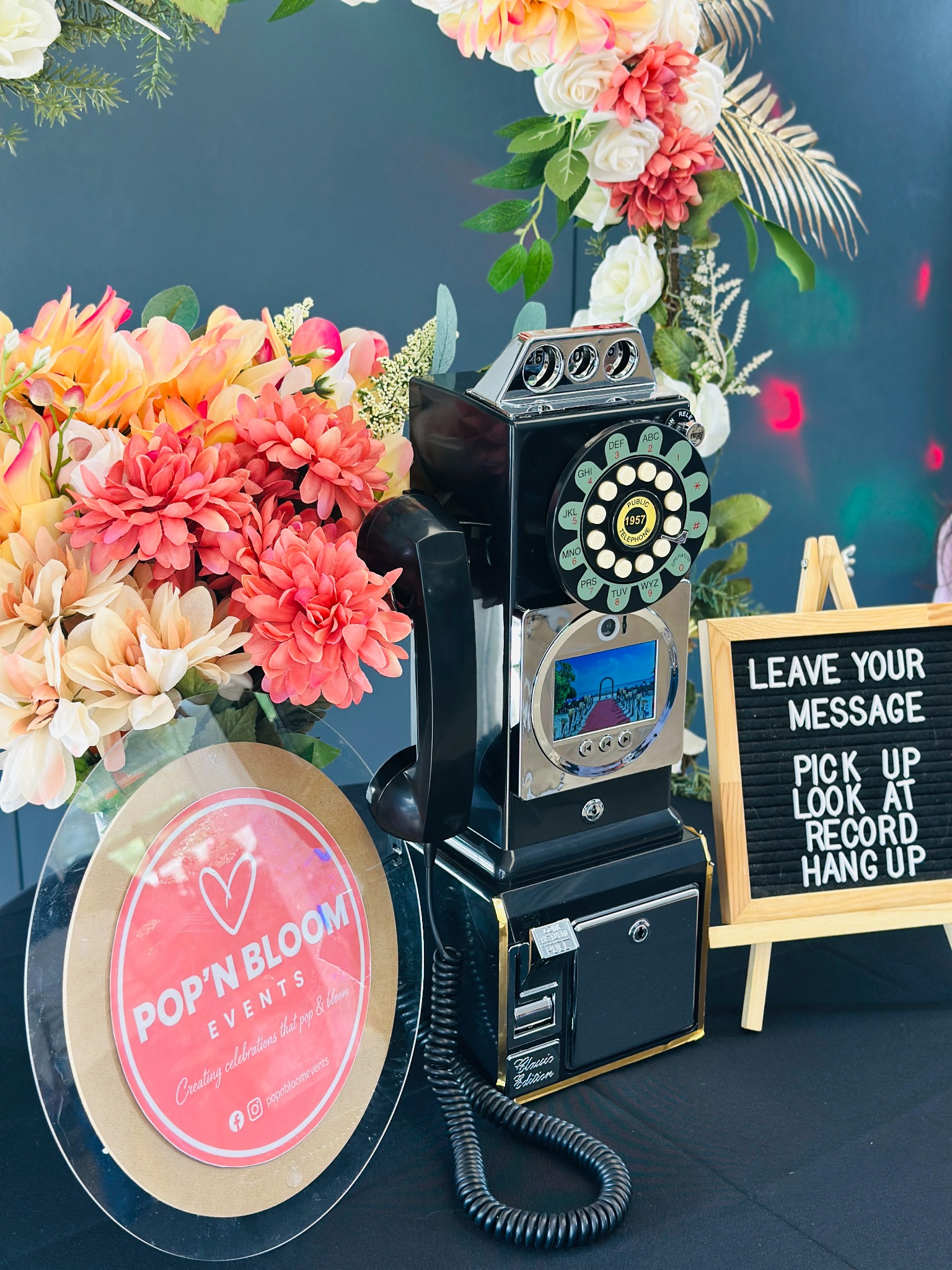 Close view of the Pop'n Bloom vintage video guestbook and coral florals