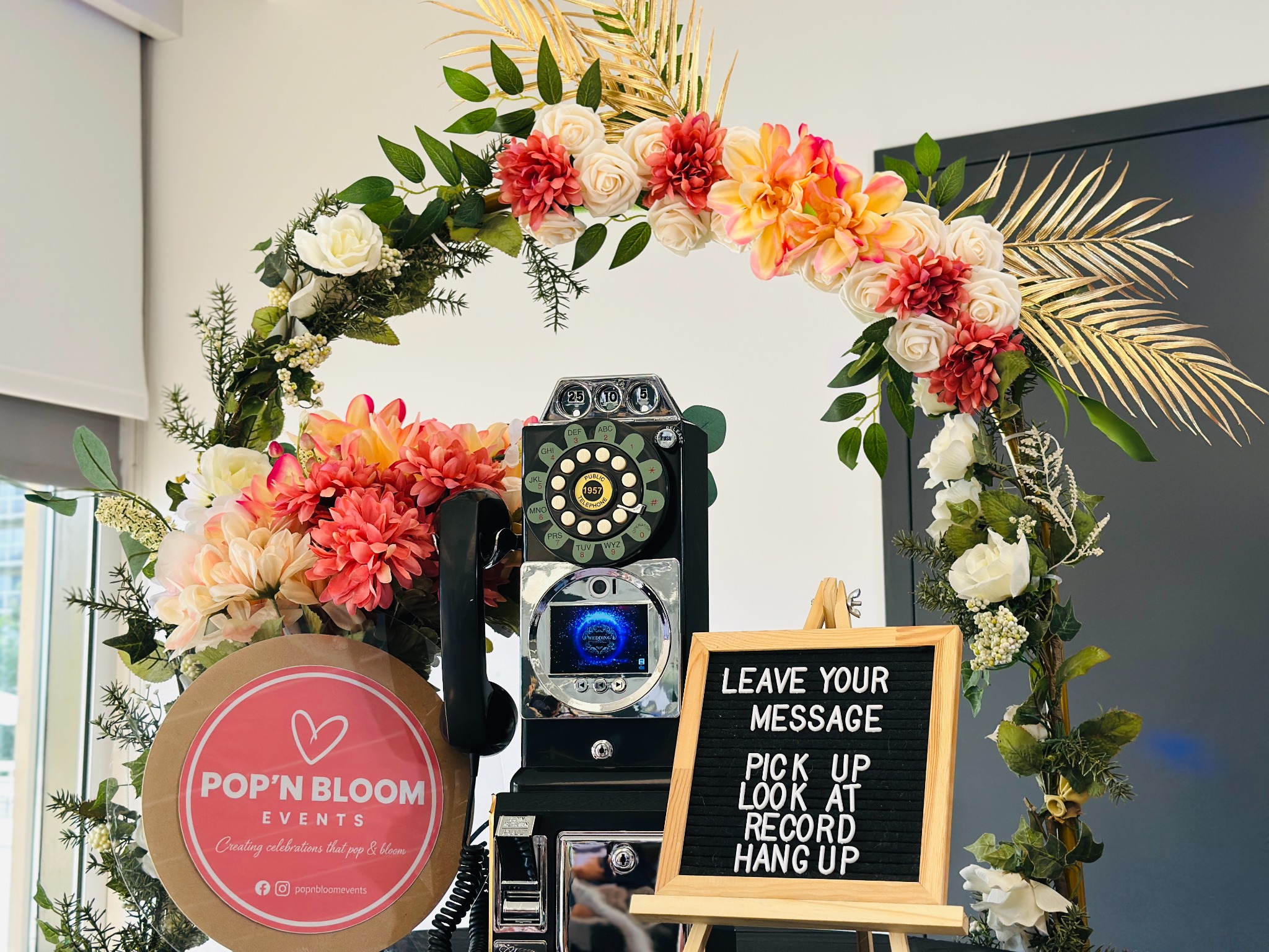 Full floral arch surrounding the video guestbook